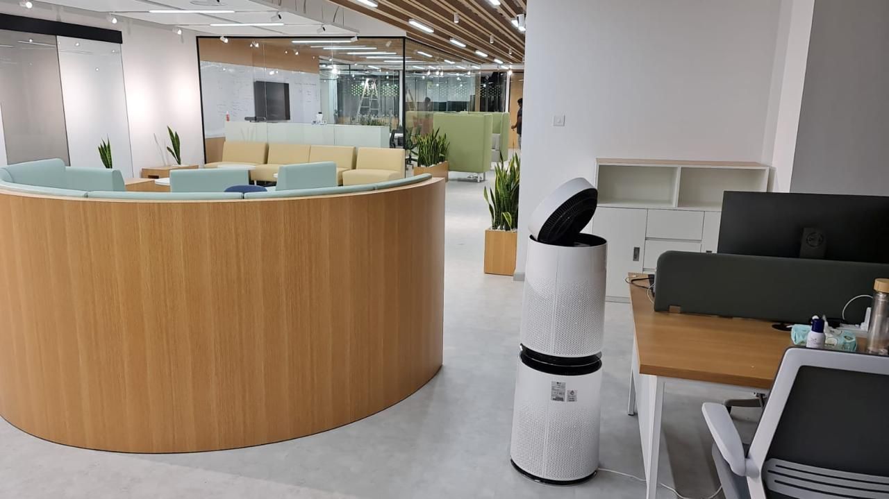 Creative agency office with a curved timber reception counter, open desks and soft seating